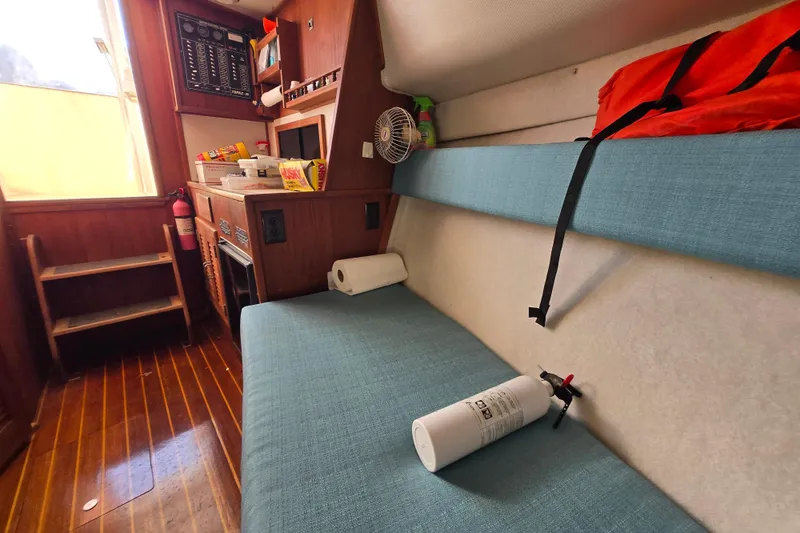 Slide: The Image of Interior of 1987 Topaz 29 Sportfisherman with seating, fire extinguisher, and storage. - 11