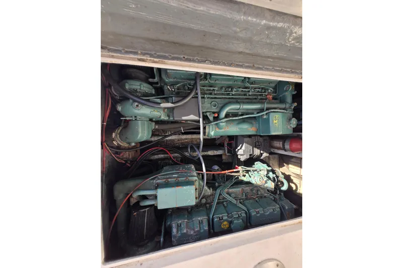 Slide: The Image of Engine compartment of a 1987 Topaz 29 Sportfisherman boat, showcasing mechanical components. - 14