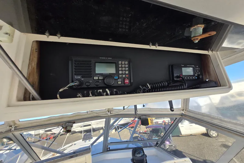 Slide: The Image of 1987 Topaz 29 Sportfisherman boat radio equipment in overhead compartment. - 15