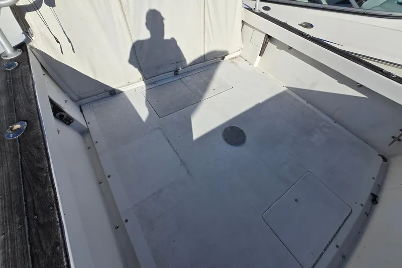 Slide: The Image of 1987 Topaz 29 Sportfisherman boat deck with shadow and hatch covers. - 5