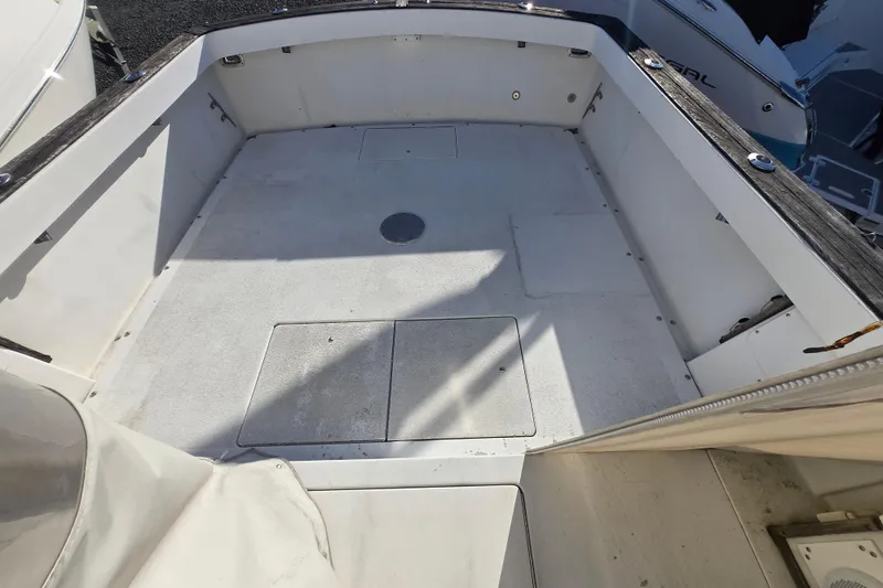Slide: The Image of 1987 Topaz 29 Sportfisherman boat deck, spacious and clean, ready for fishing adventures. - 9