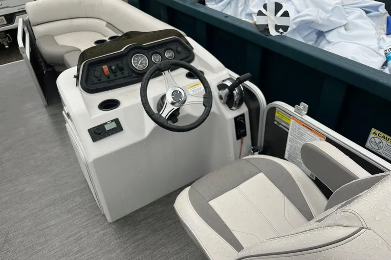 Slide: The Image of Interior of 2022 Godfrey Sweetwater 2286 SBX pontoon boat with steering console and seating. - 11