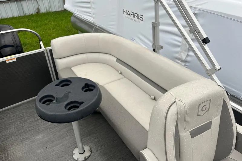 Slide: The Image of 2022 Godfrey Sweetwater 2286 SBX pontoon boat interior with seating and cup holder table. - 12