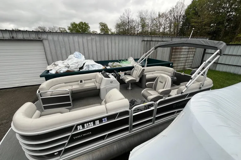 Slide: The Image of 2022 Godfrey Sweetwater 2286 SBX pontoon boat parked near a metal building. - 14