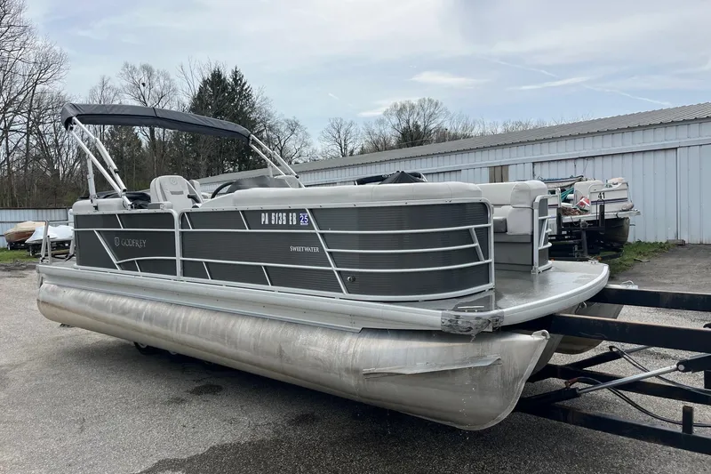 Slide: The Image of 2022 Godfrey Sweetwater 2286 SBX pontoon boat on trailer, parked outdoors. - 5
