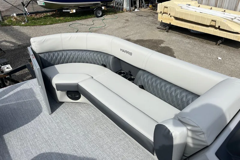 Slide: The Image of 2026 Harris Cruiser 230 SL boat interior with gray seating and cup holders. - 5