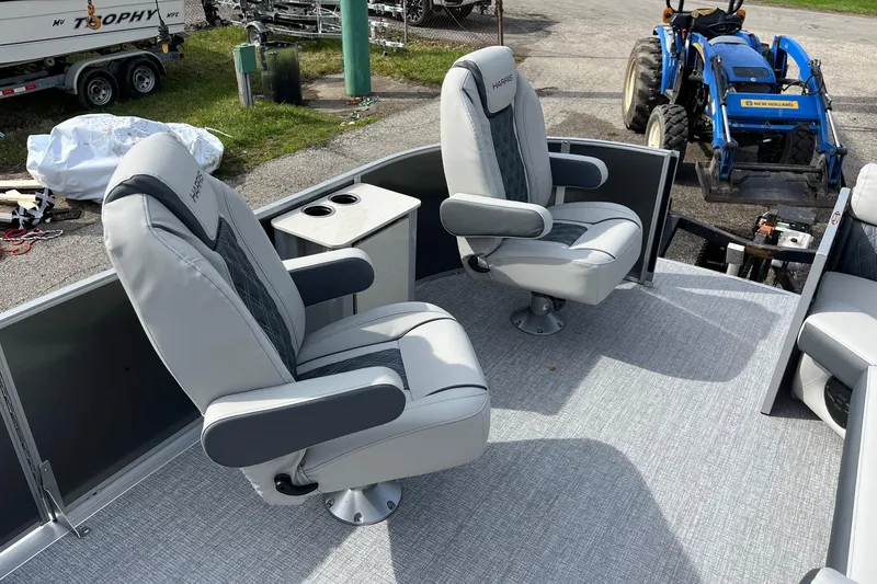 Slide: The Image of Luxury seating on 2026 Harris Cruiser 230 SL pontoon boat, featuring plush captain chairs. - 7