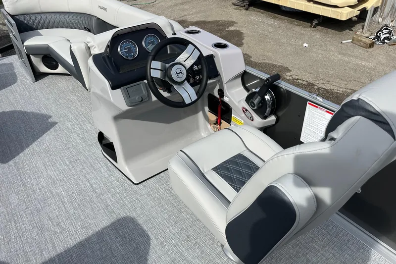 Slide: The Image of 2026 Harris Cruiser 230 SL boat interior with modern steering console and plush seating. - 9