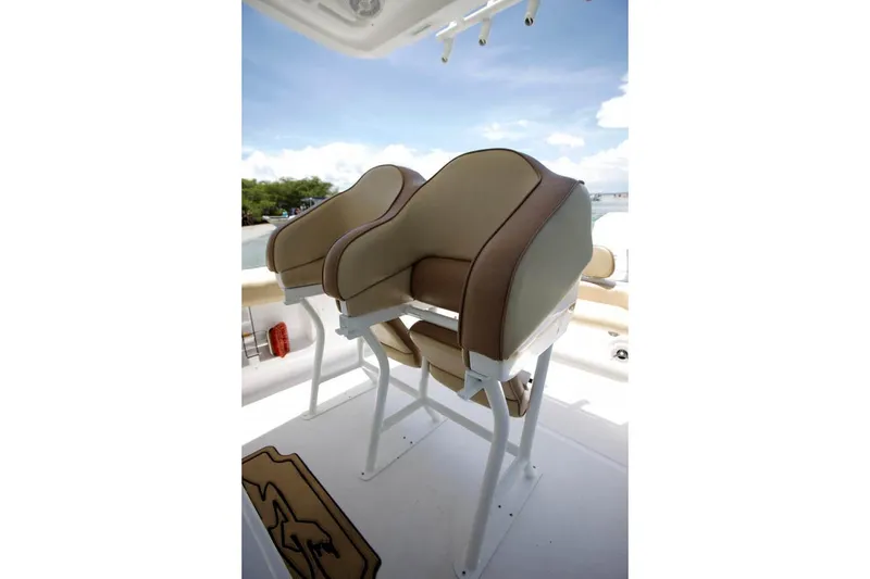 Slide: The Image of 2020 Glasstream 328 Pro-XS boat on trailer, parked on gravel under clear blue sky. - 10
