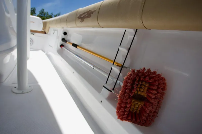 Slide: The Image of Econo Lift boat hoist system on dock, near water, with wooden planks and boots visible. - 13