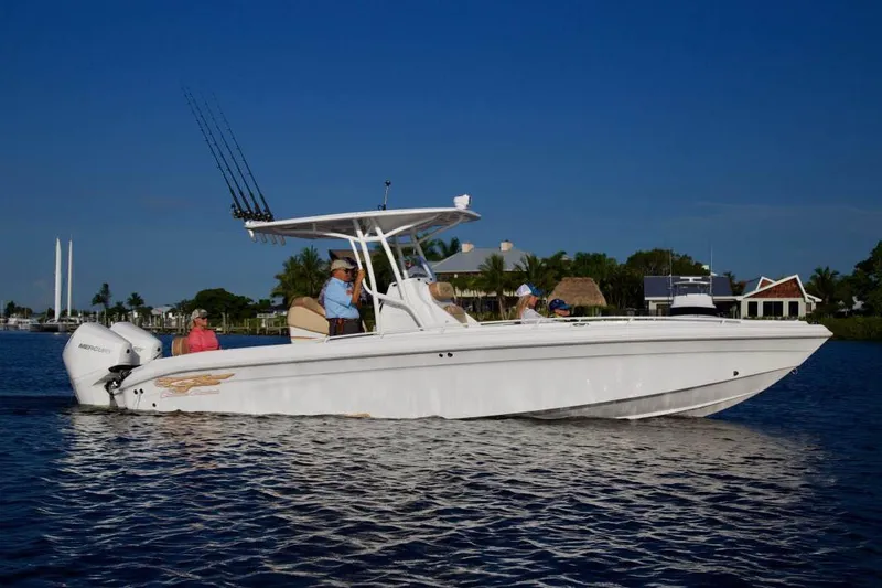 Slide: The Image of 2020 Glasstream 328 Pro-XS boat docked under a covered marina. - 2