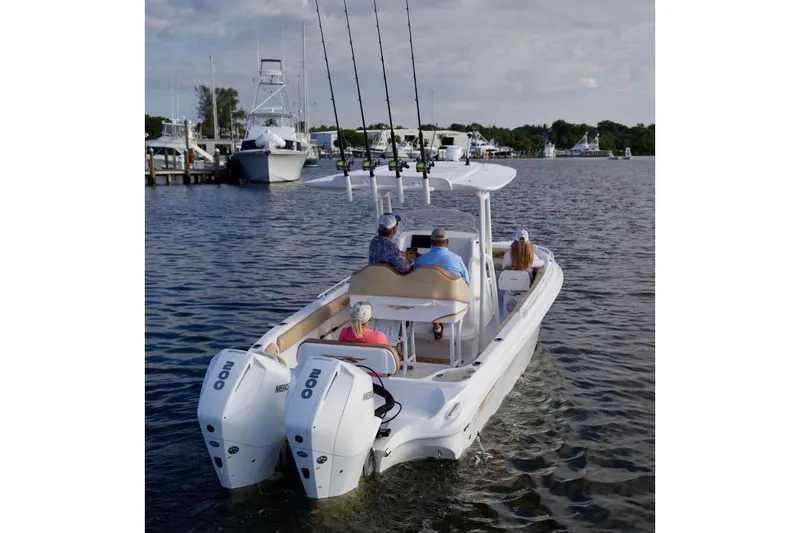 Slide: The Image of 2020 Glasstream 328 Pro-XS boat docked under a covered marina. - 4