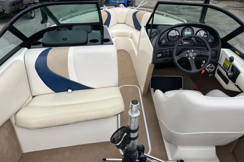Slide: The Image of 2001 Malibu Sunsetter boat interior with steering wheel, seating, and dashboard controls. - 11