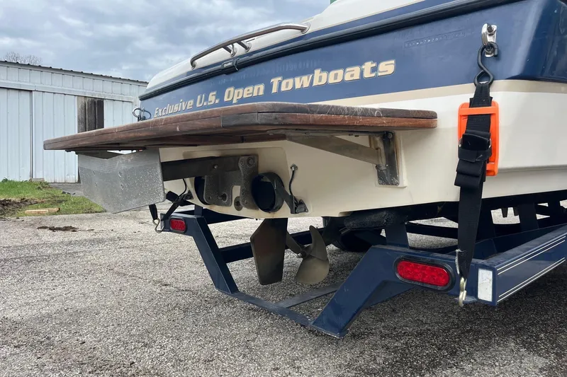 Slide: The Image of Rear view of a 2001 Malibu Sunsetter boat on a trailer, showcasing propeller and "Exclusive U.S. Open Towboats" text. - 4