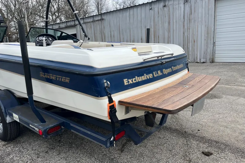 Slide: The Image of 2001 Malibu Sunsetter boat on trailer, featuring wooden swim platform and "Exclusive U.S. Open Towboat" text. - 5