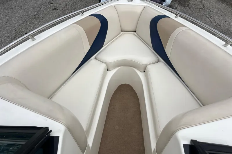 Slide: The Image of 2001 Malibu Sunsetter boat interior with beige and blue seating. - 9