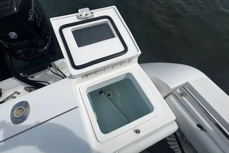 Slide: The Image of Open storage compartment on a 2015 Belzona 32 CC boat, near the engine. - 13