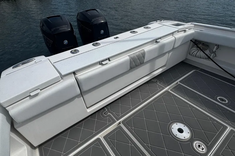 Slide: The Image of 2015 Belzona 32 CC boat with Mercury engines, featuring cushioned seating and non-slip deck. - 17