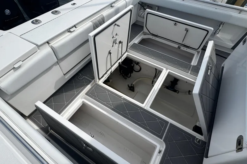Slide: The Image of 2015 Belzona 32 CC with open storage compartments in the cockpit. - 21