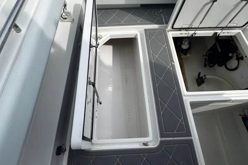 Slide: The Image of Belzona 32 CC 2015 boat storage compartments open. - 22