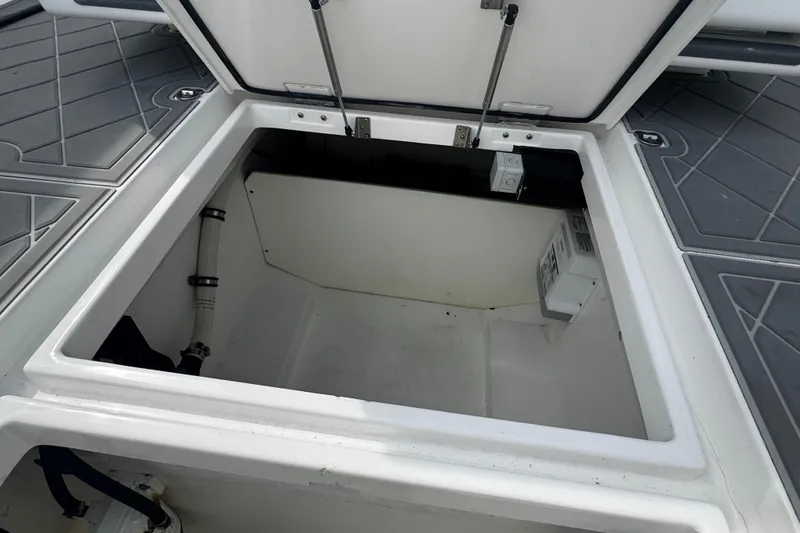 Slide: The Image of Open storage compartment in 2015 Belzona 32 CC boat. - 24
