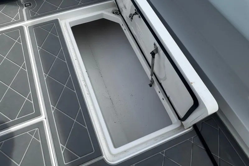 Slide: The Image of Open storage compartment on 2015 Belzona 32 CC boat. - 25