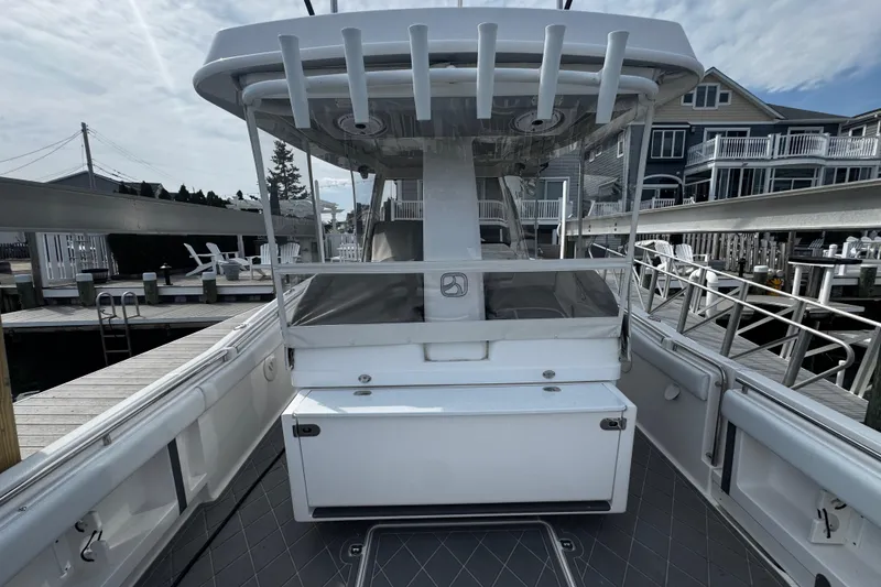 Slide: The Image of 2015 Belzona 32 CC boat docked, featuring spacious deck and modern design. - 28
