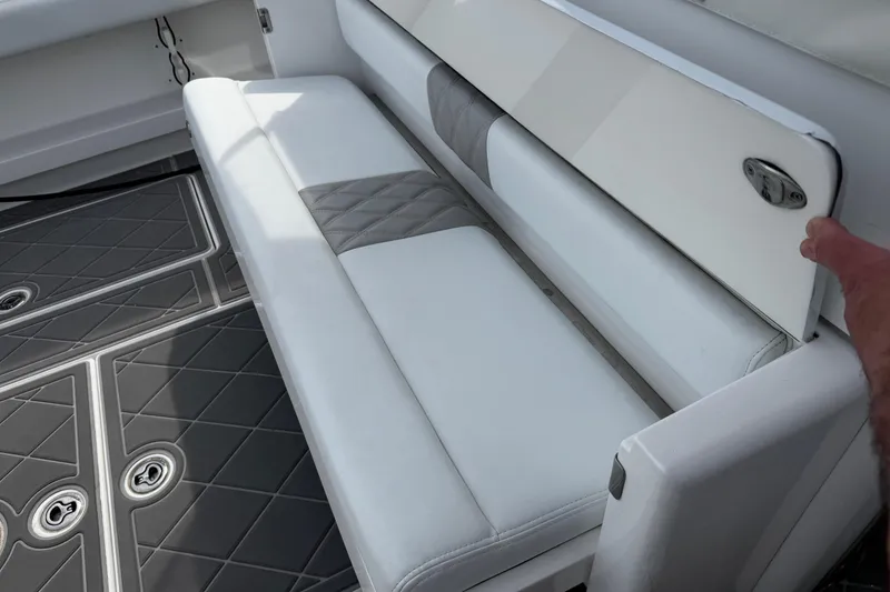 Slide: The Image of 2015 Belzona 32 CC boat interior with white cushioned seating and textured flooring. - 31