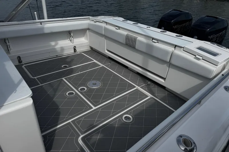 Slide: The Image of 2015 Belzona 32 CC boat deck with cushioned seating and sleek design. - 4