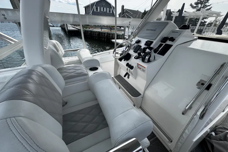 Slide: The Image of Interior view of a 2015 Belzona 32 CC boat with modern controls and seating. - 41