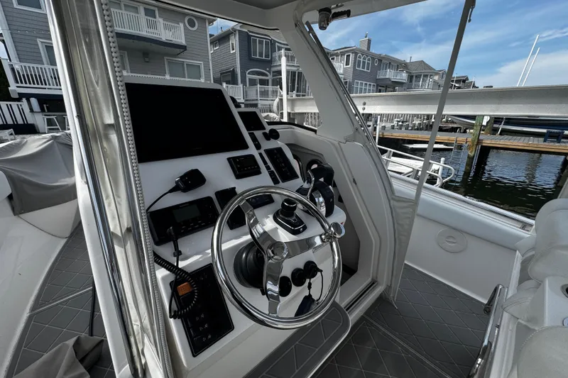 Slide: The Image of 2015 Belzona 32 CC boat cockpit with modern steering and control panel. - 45