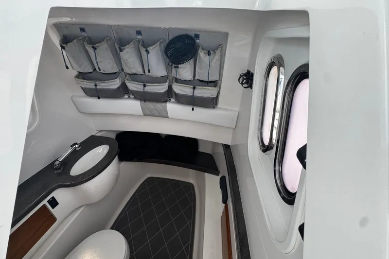 Slide: The Image of Interior of 2015 Belzona 32 CC boat with storage and compact bathroom amenities. - 47