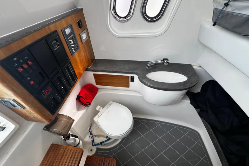 Slide: The Image of 2015 Belzona 32 CC boat interior with control panel, sink, and toilet. - 53