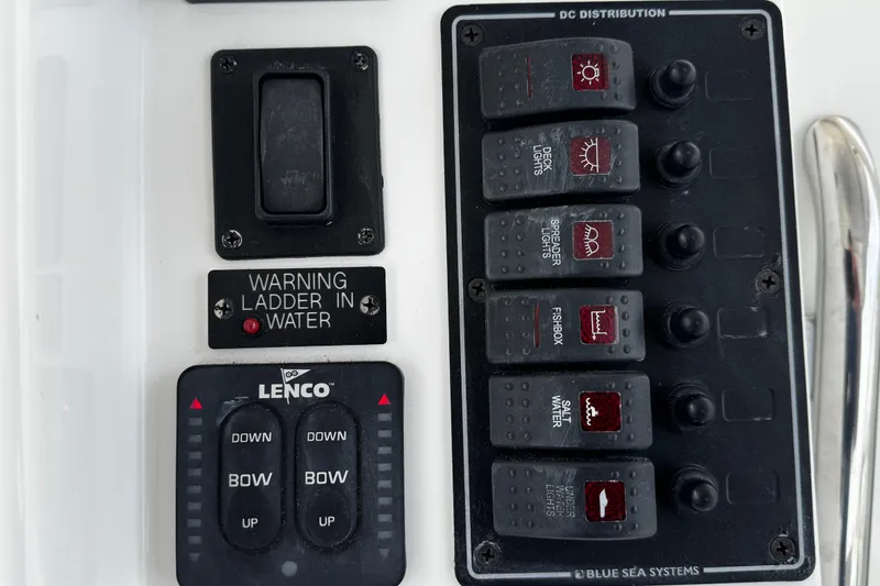 Slide: The Image of Control panel of a 2015 Belzona 32 CC boat with switches and warning indicators. - 58