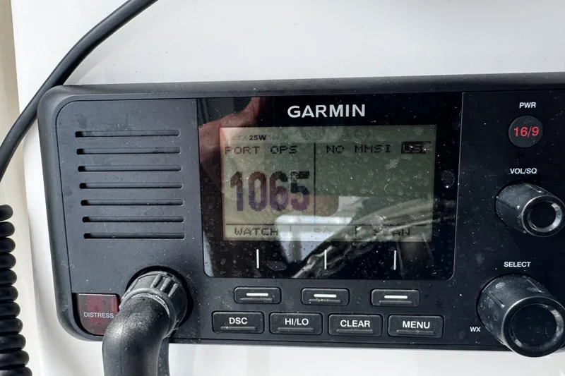 Slide: The Image of Garmin marine radio on 2015 Belzona 32 CC boat, displaying channel 1065. - 61