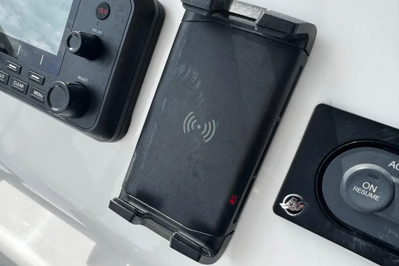 Slide: The Image of Control panel of a 2015 Belzona 32 CC boat with wireless charging dock. - 62