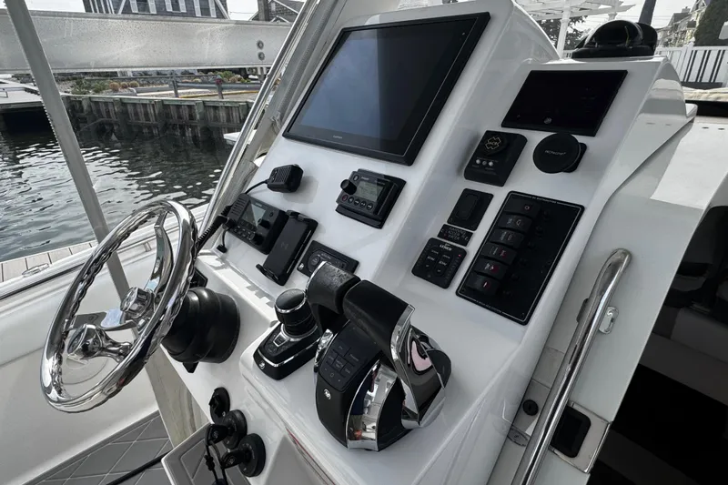 Slide: The Image of Helm of 2015 Belzona 32 CC boat with modern controls and navigation equipment. - 65