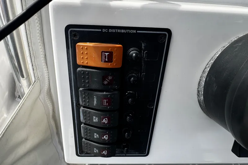 Slide: The Image of Control panel of a 2015 Belzona 32 CC boat, featuring DC distribution switches. - 66