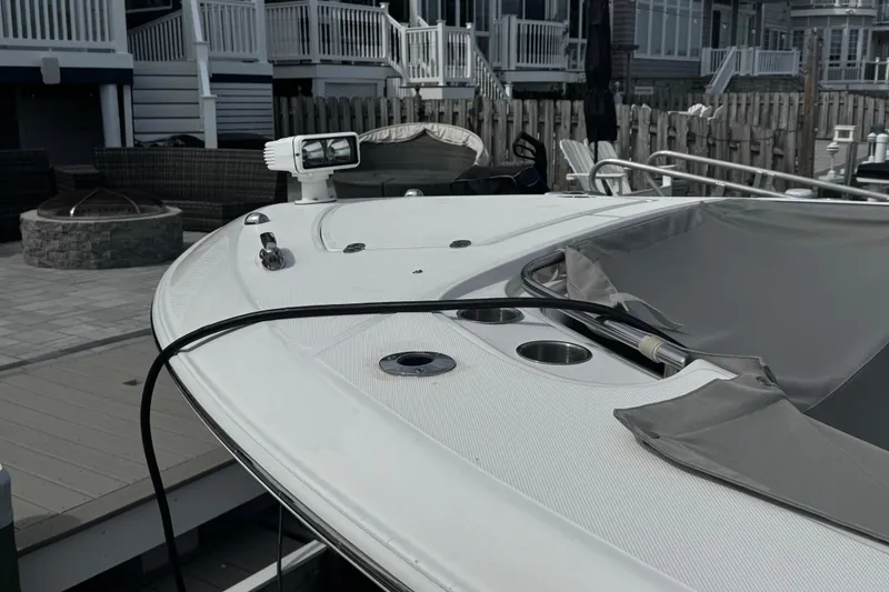 Slide: The Image of 2015 Belzona 32 CC boat docked, featuring a sleek white deck and modern fittings. - 7