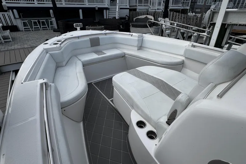 Slide: The Image of 2015 Belzona 32 CC boat interior with white seating and cup holders. - 71