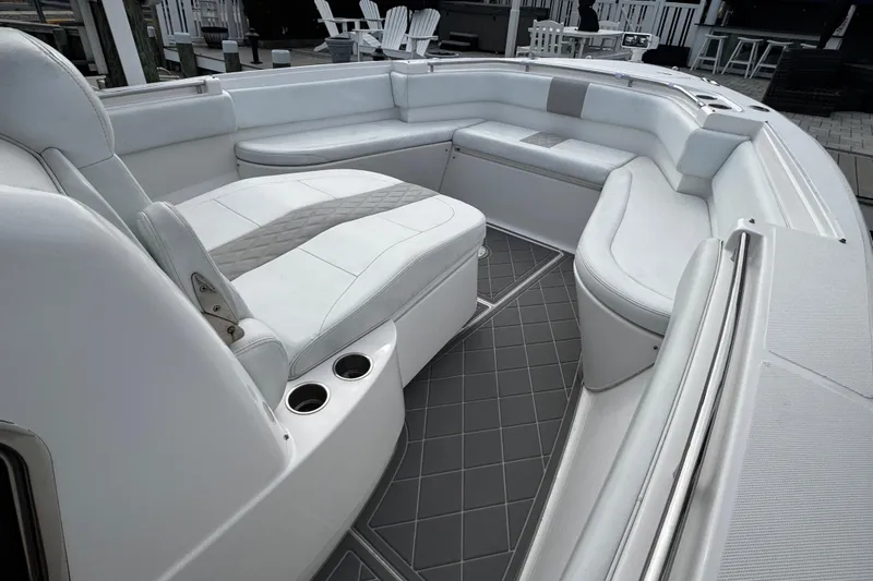 Slide: The Image of Interior of a 2015 Belzona 32 CC boat with white seating and cup holders. - 72