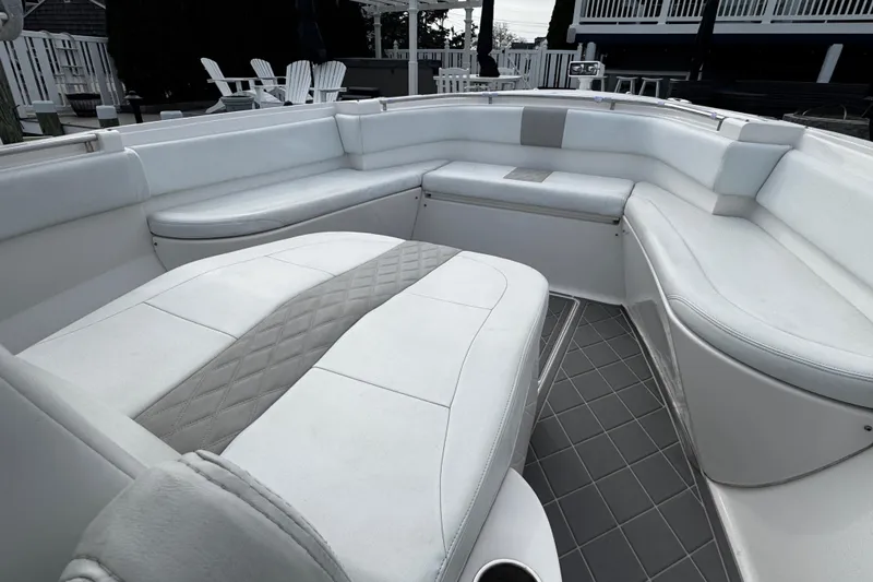 Slide: The Image of Luxurious seating area on a 2015 Belzona 32 CC boat with white upholstery. - 73