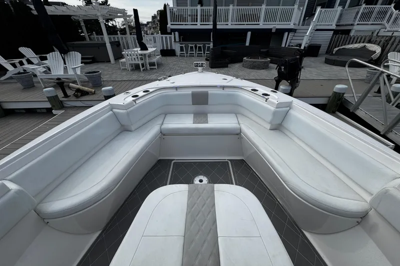 Slide: The Image of 2015 Belzona 32 CC boat with spacious white seating area at dock. - 74