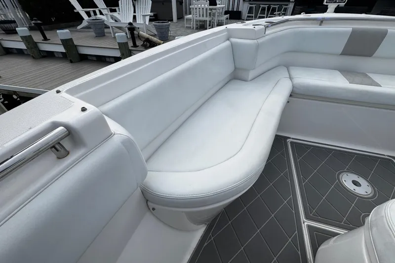 Slide: The Image of 2015 Belzona 32 CC boat interior with white seating and gray flooring. - 78