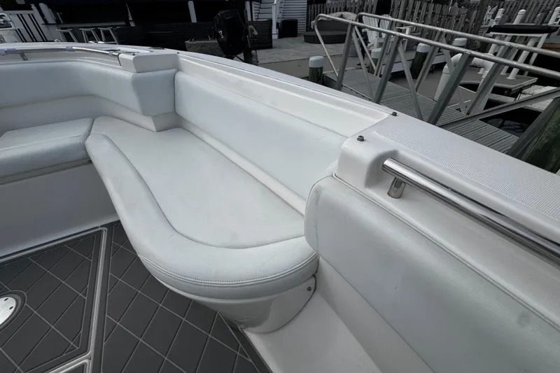 Slide: The Image of 2015 Belzona 32 CC boat interior with white cushioned seating and sleek design. - 79