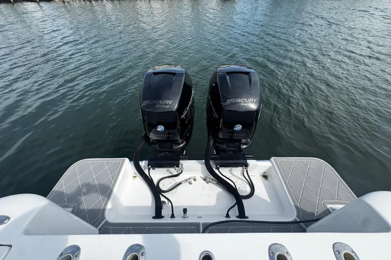 Slide: The Image of 2015 Belzona 32 CC boat with dual Mercury Racing outboard engines on water. - 8