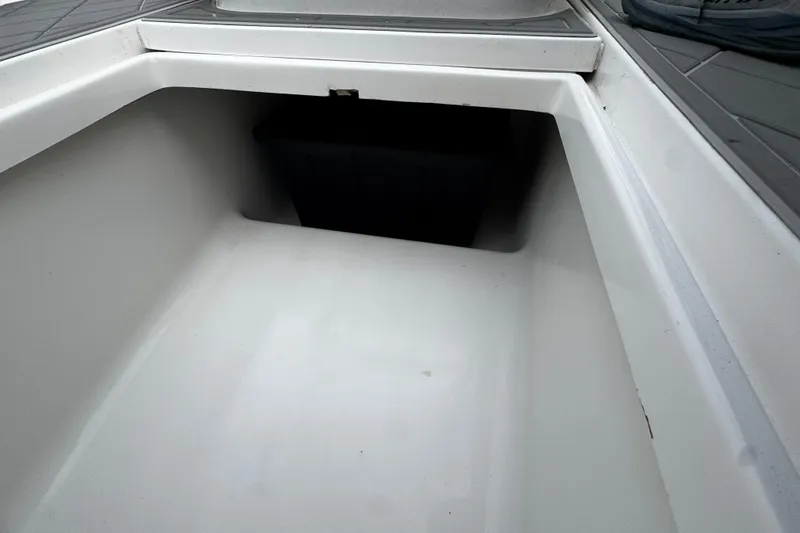 Slide: The Image of Storage compartment of a 2015 Belzona 32 CC boat, featuring a clean, spacious interior. - 82
