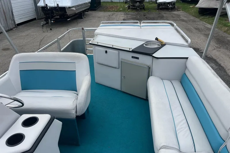 Slide: The Image of 1992 Harris FloteBote 240 Classic pontoon boat interior with seating and kitchenette. - 11
