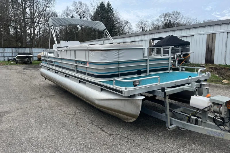 Slide: The Image of 1992 Harris FloteBote 240 Classic pontoon boat on trailer, parked outdoors. - 7