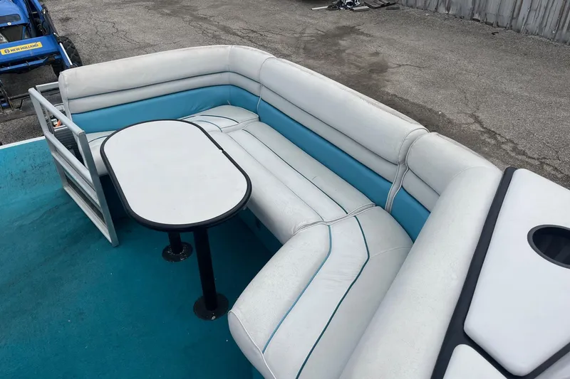 Slide: The Image of 1992 Harris FloteBote 240 Classic pontoon boat interior with white and blue seating and table. - 8